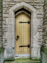 Narrow light coloured door with cast iron hinges