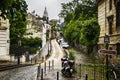 Narrow little street on Monmartre, Paris, France, leading to the Sacred Heart basilica