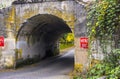 Road through an old one-way arched concrete bridge Royalty Free Stock Photo