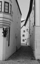 Narrow medieval paved street in black and white