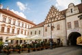 Narrow medieval square with baroque and renaissance historical buildings, Late gothic tracery gable, cityscape of medieval town in