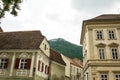 Narrow medieval street and ancient buildings in the European city of Brasov, Romania. Eastern Europe architecture Royalty Free Stock Photo