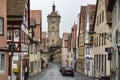 Narrow medieval street with Klingentor Gate and Tower in Rothenburg ob der Tauber, Bavaria, Germany. November 2014