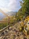 Narrow mountain path fortified with a small wooden fence Royalty Free Stock Photo