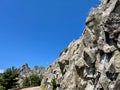 Narrow mountain road winding through rocky landscape at Bavella, Corsica, France. Royalty Free Stock Photo