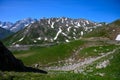Narrow mountains road from Col de Lautaret to Col du Calibier, Mountains and alpine meadows views of Massif des Ecrins, Hautes Royalty Free Stock Photo
