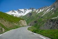 Narrow mountains road from Col de Lautaret to Col du Calibier, Mountains and alpine meadows views of Massif des Ecrins, Hautes Royalty Free Stock Photo