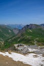 Narrow mountains road from Col de Lautaret to Col du Calibier, Mountains and alpine meadows views of Massif des Ecrins, Hautes Royalty Free Stock Photo