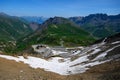 Narrow mountains road from Col de Lautaret to Col du Calibier, Mountains and alpine meadows views of Massif des Ecrins, Hautes Royalty Free Stock Photo