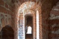 Narrow old ancient castle corridors, tunnels, arches of red stone bricks in a medieval castle Royalty Free Stock Photo