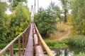 A narrow old rusty river crossing, along with a water and gas pipe. Communications in the village
