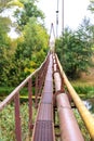 A narrow old rusty river crossing, along with a water and gas pipe. Communications in the village