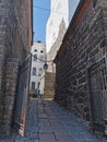 A narrow passage with a lantern suspended on chains, between the stone walls of the Vyborg Castle to the courtyard to the Tower of Royalty Free Stock Photo