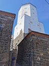 A narrow passage with a lantern suspended on chains, between the stone walls of the Vyborg Castle to the courtyard to the Tower of Royalty Free Stock Photo