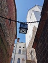 A narrow passage with a lantern suspended on chains, between the stone walls of the Vyborg Castle to the courtyard to the Tower of Royalty Free Stock Photo