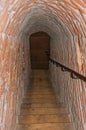 Narrow passage made of bricks with stairs inside the walls of the medieval Ammersoyen Castle.