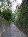 Narrow path with ancient stone walls on the side to Bergamo in Italy. 