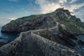 Narrow path crossing the solid stone bridge to the San Juan de Gaztelugatxe, Basque country, Spain Royalty Free Stock Photo