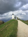 Narrow path leading to the Church of St. Primoz and Felicijan. Jamnik, Kranj, Slovenia. Royalty Free Stock Photo