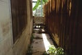 Narrow Alley Between House and Wooden Fence - Vintage Thai Backyard Royalty Free Stock Photo