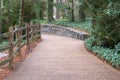 Narrow pathway with a wooden fence at a park during daytime Royalty Free Stock Photo