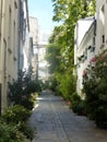 Narrow pedestrian narow street as courtyard in the center of Paris in France. Royalty Free Stock Photo