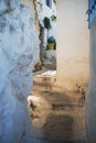 Narrow pedestrian street with stairs and white clay walls in Plaka district, Athens, Greece