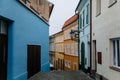 Narrow picturesque colorful street with yellow and blue baroque and renaissance historical buildings in the city center of