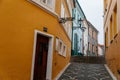 Narrow picturesque colorful street with yellow and blue baroque and renaissance historical buildings in the city center of