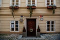 Narrow picturesque street with baroque and renaissance buildings, front wooden door with a decorative wreath, Novy svet, New World