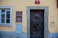 Narrow picturesque street with baroque and renaissance buildings, front wooden door with a decorative wreath, Novy svet, New World