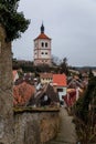 Narrow picturesque street with baroque and renaissance historical buildings, Baroque Bell tower in winter day, Roudnice nad Labem