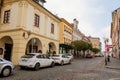 Narrow picturesque street with colorful buildings in old historic center in Kolin, baroque house with yellow stucco and ground