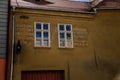 Narrow picturesque street with renaissance and baroque historical buildings, peeling plaster, inscriptions in German, wooden