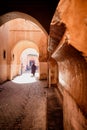 Narrow red alley street in medina of Marrakech, Morocco.