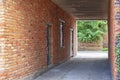 Narrow red brick wall alley in old town. Royalty Free Stock Photo