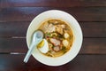 Narrow rice noodle in soup with egg and pork