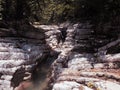 A narrow river flows between relief canyons surrounded by dense forest on a sunny summer day. Canyon white cliffs Royalty Free Stock Photo