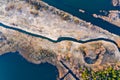 Narrow river separating dry land in autumn, aerial scenery. Environment concept Royalty Free Stock Photo