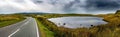 Narrow Road Beneath Small Pond In Wild Landscape Of Snowdonia National Park in Wales, United Kingdom Royalty Free Stock Photo