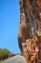 Narrow road cut in a mountain. Royalty Free Stock Photo