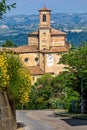 Narrow road and old brick church in Guarene, Italy. Royalty Free Stock Photo