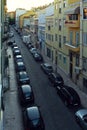 Narrow road with parked cars in Lisbon