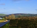 The Narrow Road that snakes across the Moors of East Lancashire with traditional drystone walls,farmhouses and reservoir