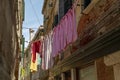 Narrow road in Venice with clotheslines between the old venetian houses Royalty Free Stock Photo