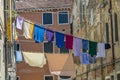 Narrow road in Venice with clotheslines between the old venetian houses Royalty Free Stock Photo