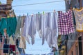 Narrow road in Venice with clotheslines between the old venetian houses Royalty Free Stock Photo