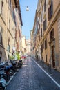 A Narrow Rome backstreet lined with motorcycles