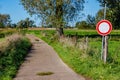 Narrow rural road with traffic sign: traffic prohibited or do not enter