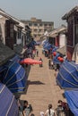 Narrow shopping street with blue awnings in Tongli, China